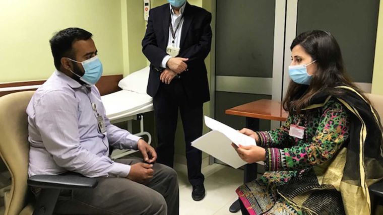 Pakistan Principal Investigator Prof. M. Asim Beg and two colleagues in a hospital setting.