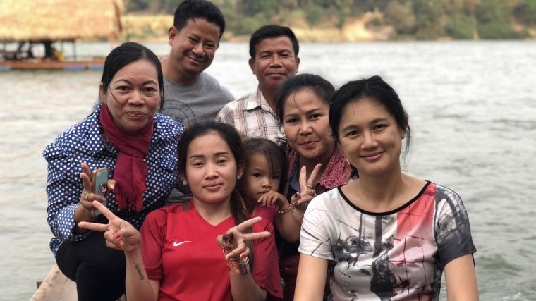 Head of Bioethics & Engagement Phaik Yeong Cheah with team members and locals at a Cambodian river crossing